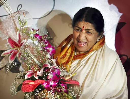 FILE- Singer Lata Mangeshkar laughs at the launch of her hindi music album 'Saadgi' or Simplicity, on World Music Day, in Mumbai, India, Thursday, June 21, 2007.  Lata Mangeshkar, legendary Indian singer with a voice recognized by a billion people in South Asia, has died at 92. (AP Photo/Rajesh Nirgude, File)(AP Photo/Rajesh Nirgude, file)