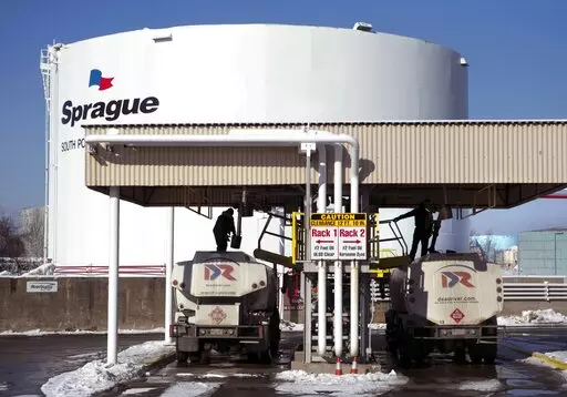 Drivers for an oil delivery company fill their trucks at the Sprague terminal, on Jan. 16, 2014, in South Portland, Maine. Diesel and heating oil supplies in the Northeast are more than 50% below the recent average, raising concerns that an extreme weather event could cause supply disruptions, federal officials said. (AP Photo/Robert F. Bukaty, File)