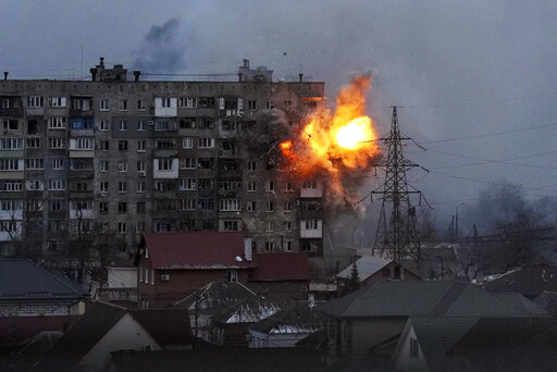Fire erupts at an apartment building in Mariupol, Ukraine, after a Russian tank opens fire on March 11, 2022. (AP Photo/Evgeniy Maloletka, File)