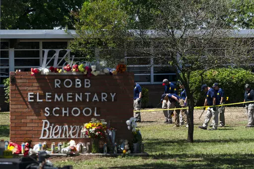 Investigators search for evidences outside Robb Elementary School in Uvalde, Texas, May 25, 2022, after an 18-year-old gunman killed 19 students and two teachers. The district’s superintendent said Wednesday, June 22, that Chief Pete Arredondo, the Uvalde school district’s police chief,  has been put on leave following allegations that he erred in his response to the mass shooting.  (AP Photo/Jae C. Hong, File)