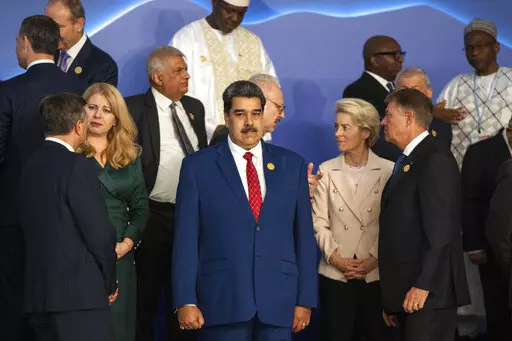 Venezuela's President Nicolas Maduro, center, stands next to the President of the European Commission Ursula von der Leyen, center right, as leaders prepare themselves for a group photo at the COP27 U.N. Climate Summit in Sharm el-Sheikh, Egypt, Nov. 7, 2022. (AP Photo/Nariman El-Mofty, File)