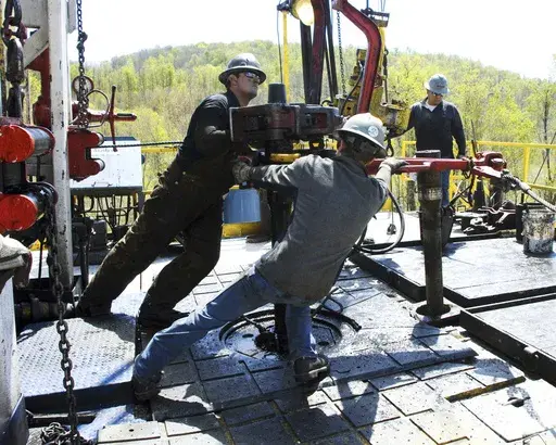 Workers move a section of well casing into place at a Chesapeake Energy natural gas well site near Burlington, Pa., in Bradford County, on April 23, 2010. (AP Photo/Ralph Wilson, File)