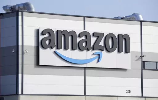 An Amazon company logo marks the facade of a building in Schoenefeld near Berlin, March 18, 2022. The Federal Trade Commission and 17 state attorney generals filed an antitrust lawsuit against Amazon on Tuesday, Sept. 26, 2023, alleging the e-commerce behemoth uses its position in the marketplace to inflate prices on other platforms, overcharge sellers and stifle competition. (AP Photo/Michael Sohn, File)