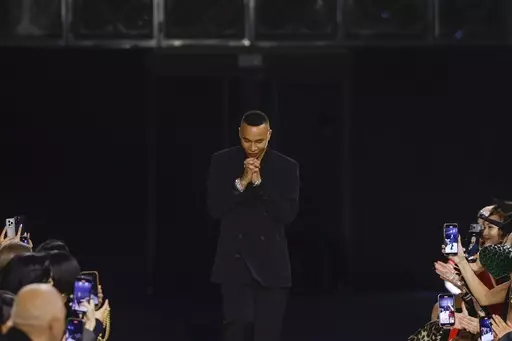 Designer Olivier Rousteing accepts applause after the conclusion of the Balmain Fall/Winter 2023-2024 ready-to-wear collection presented Wednesday, March 1, 2023 in Paris. Balmain artistic director Olivier Rousteing says robbers have made off with more than 50 pieces of the new collection that his Paris house intends to show at Fashion Week later this month. (Vianney Le Caer/Invision/AP, file)