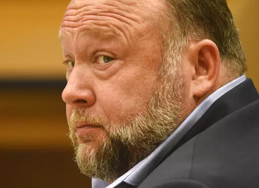 Infowars founder Alex Jones appears in court to testify during the Sandy Hook defamation damages trial at Connecticut Superior Court in Waterbury, Conn., on Thursday, Sept. 22, 2022. A six-person jury reached a verdict Wednesday, Oct. 12, 2022, saying that Jones should pay $965 million to 15 plaintiffs who suffered from his lies about the Sandy Hook school massacre. Jones and his company were found liable for damages last year. (Tyler Sizemore/Hearst Connecticut Media via AP, Pool, File)