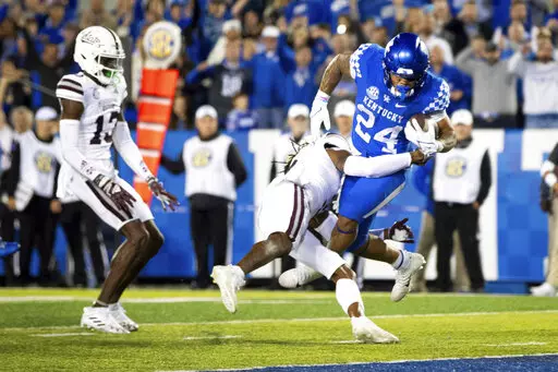 Kentucky running back Chris Rodriguez Jr. (24) is tackled into the end zone for a touchdown by Mississippi State defensive end Jordan Davis during the second half of an NCAA college football game in Lexington, Ky., Saturday, Oct. 15, 2022. (AP Photo/Michael Clubb)