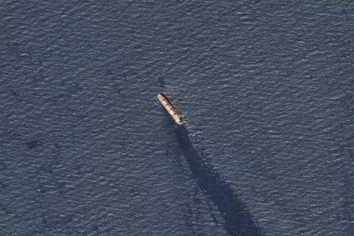 In this satellite image provided by Planet Labs, the Belize-flagged bulk carrier Rubymar is seen in the southern Red Sea near the Bay el-Mandeb Strait leaking oil after an attack by Yemen's Houthi rebels Tuesday, Feb. 20, 2024. Despite a month of U.S.-led airstrikes, Yemen's Iran-backed Houthi rebels remain capable of launching significant attacks. This week, they seriously damaged a ship in a crucial strait and apparently downed an American drone worth tens of millions of dollars. (Planet Labs 