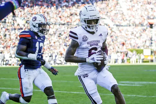 Mississippi State wide receiver Jamire Calvin (6) gets past Auburn safety Ladarius Tennison (13) and carries the ball in for a touchdown during the second half of an NCAA college football game Saturday, Nov. 13, 2021, in Auburn, Ala. (AP Photo/Butch Dill)