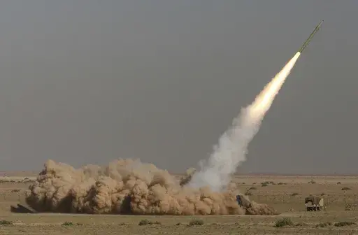 In this photo released by the Iranian semi-official Fars News Agency, Revolutionary Guard's Fateh missile is launched in a drill near the city of Qom, 80 miles (130 kilometers) south of the capital Tehran, Iran, Sept. 27, 2009. (Ali Shaigan/Fars News Agency via AP File)