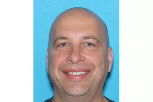 This drivers license image contained in the Statement of Facts supporting an arrest warrant, released by the Justice Department, shows Robert Sanford. Sanford, a retired firefighter who threw a fire extinguisher at police officers during the U.S. Capitol riot on Jan. 6, 2021, has been sentenced to more than four years in prison. (Justice Department via AP)