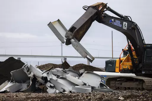 A shearer breaks apart salvaged pieces of the collapsed Francis Scott Key Bridge at Tradepoint Atlantic, Friday, April 12, 2024, in Sparrows Point, Md. (AP Photo/Julia Nikhinson)