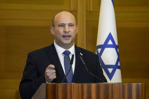 Israeli Prime Minister Naftali Bennett delivers a statement at the Knesset, Israel's parliament, in Jerusalem, Wednesday, June 29, 2022. Bennett will not run in upcoming elections, after he led a broad but fragile coalition government that came unraveled barely a year after taking office. (AP Photo/Tsafrir Abayov)