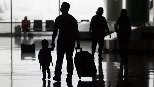 People travel through Salt Lake City International Airport on Wednesday, Feb. 22, 2023, in Salt Lake City. When discussing a multigenerational family trip, have a plan to avoid arguments around topics like when to travel, where you’ll go, what you’ll do there or how you’ll split bills. With groups, it’s often best for each family unit to book their lodging and transportation. (AP Photo/Rick Bowmer, File)