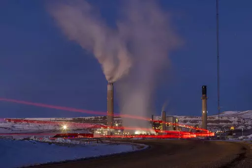 In this photo taken with a slow shutter speed, taillights trace the path of a motor vehicle at the Naughton Power Plant, Thursday, Jan. 13, 2022, in Kemmerer, Wyo. While the power plant will be closed in 2025, Bill Gates' company TerraPower announced it had chosen Kemmerer for a nontraditional, sodium-cooled nuclear reactor that will bring on workers from a local coal-fired power plant scheduled to close soon. The U.S. nuclear industry has provided a steady 20% of the nation's power for years, b
