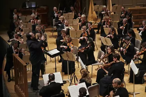 FILE — Andris Nelsons conducts a joint concert of the Boston Symphony Orchestra and Germany's visiting Leipzig Gewandhaus Orchestra at Symphony Hall, in Boston, Thursday, Oct. 31, 2019. Haunted by the horrors of the war in Ukraine, the Boston Symphony Orchestra is sounding a decidedly somber note as it prepares for its 2022-23 season. (AP Photo/Elise Amendola, File)