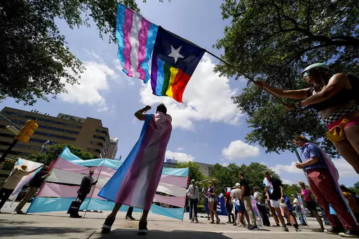 Demonstrators gather on the steps to the State Capitol to speak against transgender-related legislation bills being considered in the Texas Senate and House, May 20, 2021, in Austin, Texas. A federal ruling on Aug. 16, 2022, that gender dysphoria is covered by the Americans with Disabilities Act, could help block conservative political efforts to restrict access to gender-affirming care, advocates and experts say. (AP Photo/Eric Gay, File)