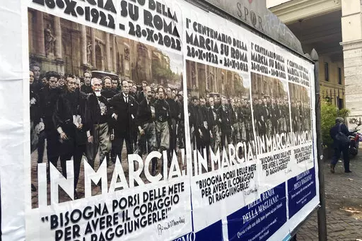 Posters commemorating the 100th anniversary of the March on Rome bearing a picture of Italian Fascist Dictator Benito Mussolini reading: "Marching!" with a quote by Mussolini "you have to set yourself goals to have the courage to reach them" are posted on the Rome's public billboard space, Thursday, Oct. 27, 2022. The posters were later ordered removed by Rome's Mayor Roberto Gualtieri. (AP Photo/Gregorio Borgia)