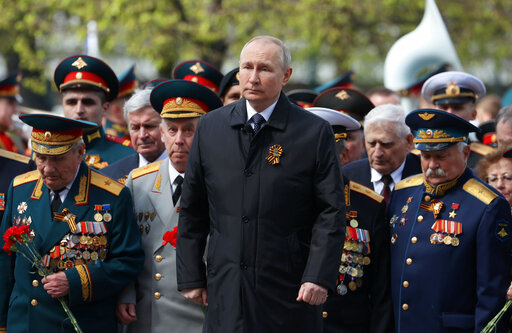 Russian President Vladimir Putin, centre, attends a wreath-laying ceremony at the Tomb of the Unknown Soldier after the military parade marking the 77th anniversary of the end of World War II, in Moscow, Russia, Monday, May 9, 2022. (Anton Novoderezhkin, Sputnik, Kremlin Pool Photo via AP)