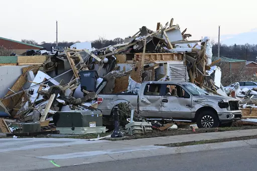 A damaged car sits by homes destroyed from severe weather in the West Creek Farms neighborhood on Sunday, Dec. 10, 2023, Clarksville, Tenn. If your home was hit by high water or a fire emergency, would your important papers be safe? Items like insurance information, birth and marriage certificates, passports, Social Security cards and estate planning paperwork should all be protected in case the worst happens. (AP Photo/Mark Zaleski, File)