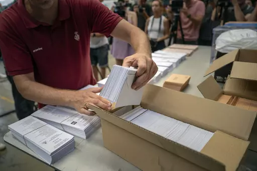 An election worker shows ballots to the media before being distributed at polling stations, at a warehouse in Barcelona, Spain, July 18, 2023. Claims of vote rigging and election fraud are spreading in Spain ahead of that nation's pivotal election on Sunday. The allegations are strikingly similar to claims spread by ex-President Donald Trump and others in the United States ahead of the 2020 election. (AP Photo/Emilio Morenatti, File)