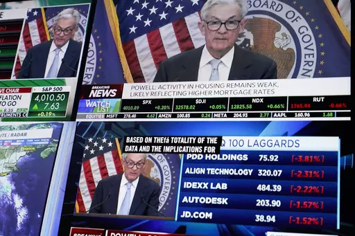 Displays show Fed chairman Jerome Powell's news conference while traders work on the floor at the New York Stock Exchange in New York, Wednesday, March 22, 2023. (AP Photo/Seth Wenig)
