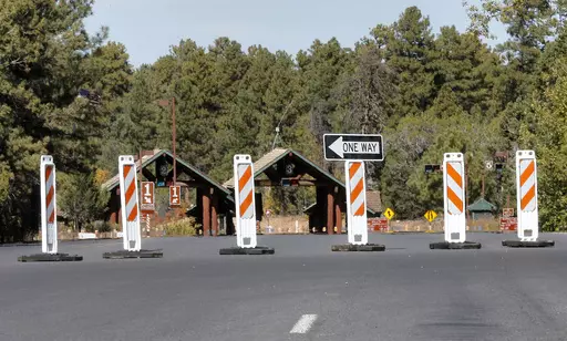 The Grand Canyon National Park entrance is blocked off, in Tusayan, Ariz., Oct. 8, 2013, because of a partial government shutdown. Arizona's Grand Canyon National Park and all five national parks in Utah will remain open if the U.S. government shuts down, Sunday, Oct. 1, 2023. Arizona Gov. Katie Hobbs and Utah Gov. Spencer Cox say that the parks are important destinations and local communities depend on dollars from visitors. (AP Photo/Matt York, File)