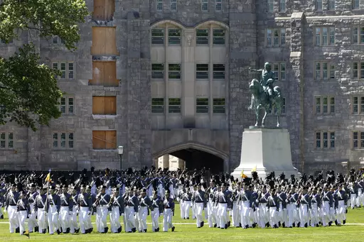 In this May 22, 2019 photo members of the senior class march past a statue of George Washington during Parade Day at the U.S. Military Academy in West Point, N.Y. "Duty, Honor, County" has been the motto of the U.S. Military Academy at West Point since 1898. The motto isn't changing, but a decision to take those words out of the school's lesser-known mission statement is generating outrage in certain quarters. (AP Photo/Mark Lennihan, File)