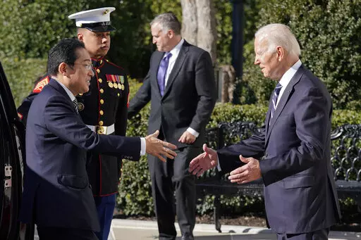 President Joe Biden greets Japanese Prime Minister Fumio Kishida on the South Lawn of the White House, Friday, Jan. 13, 2023, in Washington. (AP Photo/Evan Vucci)