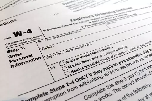 A W-4 form on Feb. 5, 2020, in New York. Monday is Tax Day, the federal deadline for individual tax filing and payments. The IRS will receive tens of millions of filings electronically and through paper forms. (AP Photo/Patrick Sison, File)