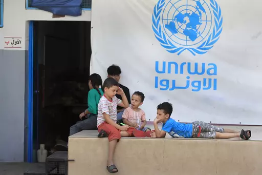 Palestinian children who fled with their parents from their houses in the Palestinian refugee camp of Ein el-Hilweh, gather in the backyard of an UNRWA school, in Sidon, Lebanon, Sept. 12, 2023. An independent review released Monday, April 22, 2024, of the neutrality of UNRWA, the U.N. agency helping Palestinian refugees, has found that Israel never expressed concern about anyone on the staff lists it has received annually since 2011. The review was carried out after Israel alleged that a dozen 
