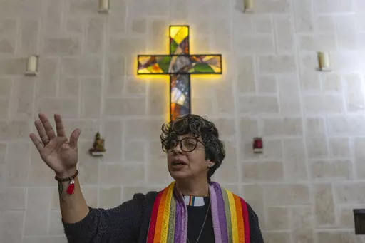 Rev. Elaine Saralegui, wearing a rainbow-colored clergy stole and her clerical collar, leads a service at the Metropolitan Community Church, an LGBTQ+ inclusive house of worship, in Matanzas, Cuba, Friday, Feb. 2, 2024. In recent years, the communist-run island barred anti-gay discrimination, and a 2022 government-backed “family law” — approved by popular vote — allowed same-sex couples the right to marry and adopt. (AP Photo/Ramon Espinosa) (AP Photo/Ramon Espinosa)