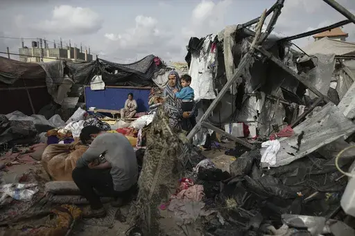 Displaced Palestinians inspect their tents destroyed by Israel's bombardment, adjunct to an UNRWA facility west of Rafah city, Gaza Strip, Tuesday, May 28, 2024. (AP Photo/Jehad Alshrafi, File)