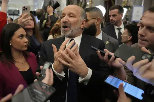 Secretary of Commerce Howard Lutnick speaks with reporters after President Donald Trump addressed a joint session of Congress at the Capitol in Washington, Tuesday, March 4, 2025. (AP Photo/Ben Curtis)
