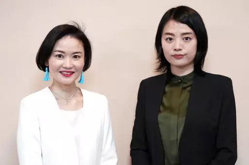 Prosecutors Tomoko Suzuki, left, and Rina Ito pose for a photographer during an interview at Tokyo District Public Prosecutors Office Monday, Feb. 27, 2023, in Tokyo. Twenty years ago, only about 8% of Japanese prosecutors were women. By 2018, that number rose to nearly a third of newly hired prosecutors. This year, the male-female ratio reached 50-50, according to the Tokyo District Prosecutors Office. (AP Photo/Eugene Hoshiko)