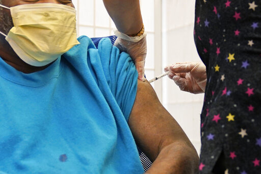 A 62-year-old nursing home resident receives a COVID-19 booster shot in New York on Monday, Sept. 27, 2021. A study released on Wednesday, Jan. 19, 2022 that compares coronavirus protection from prior infection and vaccination in New York and California concludes getting the shots is still the safest way to prevent COVID-19. (AP Photo/Seth Wenig, File)