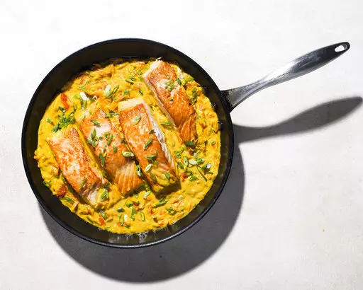 This image released by Milk Street shows a recipe for Salmon in Coconut-Curry Sauce. (Milk Street via AP)