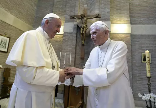 Pope Francis, left, and Pope Benedict XVI, meet each other on the occasion of the elevation of five new cardinals at the Vatican, on June 28, 2017. Pope Francis has exposed the political “maneuvers” to sway votes during the past two conclaves and denied he is planning to reform the process to elect a pope in a new book-length interview published Tuesday April 2, 2024. (L'Osservatore Romano/Pool photo via AP, File)