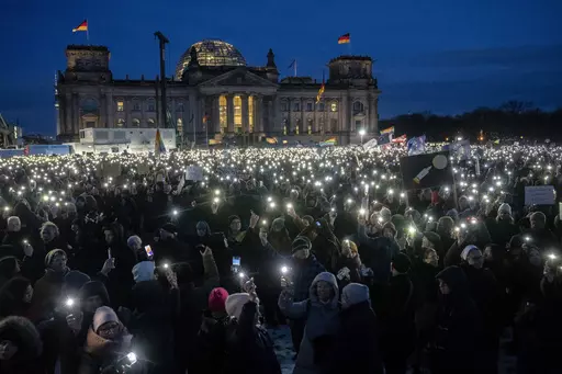 People hold up their cell phones as they protest the far-right Alternative for Germany, or AfD party, and right-wing extremism in front of the parliament building in Berlin, Germany, Jan. 21, 2024. Millions of Germans have joined rallies all over the country for weeks in a row, attending events with slogans such as "Never Again is Now." The protesters have been alarmed by the AfD's policies and its growing popularity. (AP Photo/Ebrahim Noroozi, File)