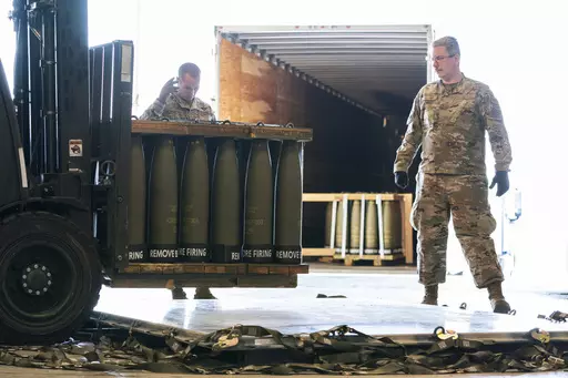 Airmen with the 436th Aerial Port Squadron place 155 mm shells on aircraft pallets ultimately bound for Ukraine, April 29, 2022, at Dover Air Force Base, Del. Half of the people in the U.S. support the Pentagon's ongoing supply of weapons to Ukraine for its defense against Russian forces. That's according to a new survey by the University of Chicago's Harris School of Public Policy and NORC. (AP Photo/Alex Brandon, File)