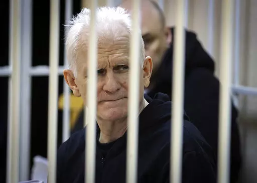 Ales Bialiatski, the head of Belarusian Vyasna rights group, sits in a defendants' cage during a court session in Minsk, Belarus, on Thursday Jan. 5, 2023. A Belarusian court has sentenced Ales Bialiatski, Belarus' top human rights advocate and one of the winners of the 2022 Nobel Peace Prize, to 10 years in prison. Bialiatski and three other top figures of the Viasna human rights center he founded were convicted of financing anti-government protests. (Vitaly Pivovarchyk/BelTA Pool Photo via AP,