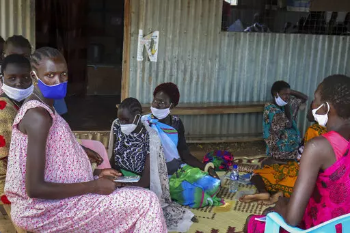 Expectant mothers sit on the floor as they wait to attend a monthly checkup at the Mingkaman Reproductive Health Clinic in the village of Mingkaman, Awerial County, in the Lakes State of South Sudan Wednesday, Oct. 19, 2022. In a country with one of the world's highest maternal mortality rates, the small clinic dedicated to reproductive health care for more than 200,000 people is about to be shut down - just one casualty among many in developing countries as humanitarian donors are stretched by 
