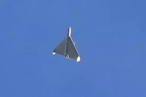 A drone is seen in the sky seconds before it fired on buildings in Kyiv, Ukraine, Monday, Oct. 17, 2022. (AP Photo/Efrem Lukatsky)