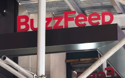 The entrance to BuzzFeed in New York is seen on Nov. 19, 2020. Pulitzer prize winning digital media company BuzzFeed is cutting about 15% of its staff, according to multiple media reports. In a memo sent to staff, co-founder and CEO Jonah Peretti said that the New York company was going to start the process of shutting down its news division, and that cuts would also occur across its business, content, tech and administrative teams. (AP Photo/Ted Shaffrey, File)