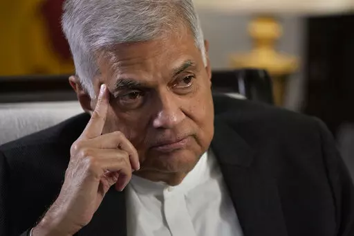 Sri Lanka's new prime minister Ranil Wickremesinghe gestures during an interview with The Associated Press in Colombo, Sri Lanka, Saturday, June 11, 2022. Sri Lanka may be compelled to buy more oil from Russia amid the island nation's unprecedented economic crisis, even as Western nations have largely boycotted Moscow as punishment for its invasion of Ukraine, the newly appointed prime minister said. (AP Photo/Eranga Jayawardena)
