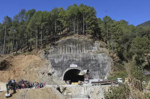 FILE- People watch rescue and relief operations at the site of an under-construction road tunnel that collapsed in mountainous Uttarakhand state, India, Wednesday, Nov. 15, 2023. All 41 construction workers who were trapped have been pulled out after 17 days, on Tuesday, Nov. 28. The efforts to reach the workers, aided by international tunneling experts and spearheaded by multiple Indian rescue agencies, was one of the most significant and complicated rescue operations in India’s recent histor