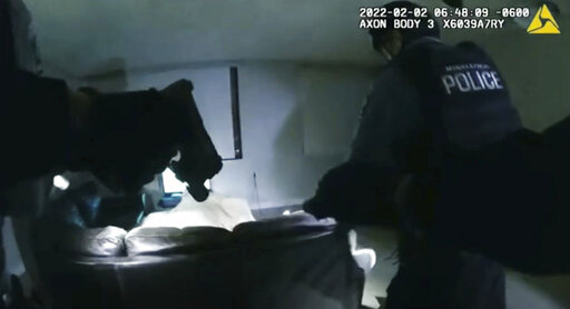 In this image taken from Minneapolis Police Department body camera video and released by the city of Minneapolis, Minneapolis police enter an apartment on Wednesday, Feb. 2, 2022, moments before shooting 22-year-old Amir Locke. Minneapolis Mayor Jacob Frey has imposed a moratorium on no-knock warrants after Locke was killed as a SWAT team carried out a search warrant in a downtown apartment. (Minneapolis Police Department via AP)