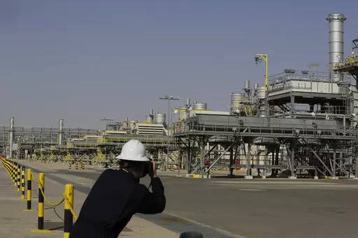 A photographer takes pictures of the Khurais oil field during a tour for journalists, 150 km east-northeast of Riyadh, Saudi Arabia, June 28, 2021. In a statement on Monday, March 21, 2022, carried by the state-run Saudi Press Agency, Saudi Arabia said it “won’t bear any responsibility for any shortage in oil supplies to global markets” after attacks by Yemen’s Iran-backed Houthi rebels have affected the kingdom’s production. (AP Photo/Amr Nabil, File)