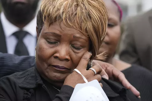 Bettersten Wade, mother of Dexter Wade, a 37-year-old man who died after being hit by a Jackson, Miss., police SUV driven by an off-duty officer, wipes away tears as she watches her son's body transferred to a mortuary transport, after being exhumed from a pauper's cemetery near the Hinds County Penal Farm in Raymond, Monday, Nov. 13, 2023. Civil rights attorney Ben Crump said Monday he is asking the U.S. Justice Department to investigate why authorities waited several months to notify the famil