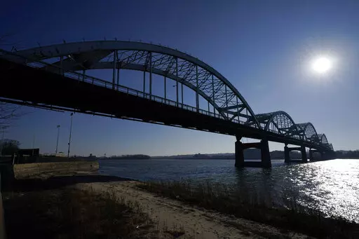 The Centennial Bridge is seen over the Mississippi River, Monday, Dec. 20, 2021, in Davenport, Iowa. The 81-year-old bridge creaks under the weight of tens of thousands of cars and trucks every day and rust shows through its chipped silver paint, exposing the steel that needs replacing. This city's aging landmark is among more than 1,000 structurally deficient bridges in the area. The tally gives Iowa's 2nd congressional district the dubious distinction of having the second-most troubled bridges
