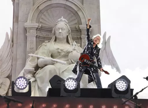 Queen guitarist Brian May performs during the Platinum Jubilee concert taking place in front of Buckingham Palace, London, on June 4, 2022, on the third of four days of celebrations to mark the Platinum Jubilee. Brian May is now a “Sir.” May, who also has a doctorate in astrophysics and is an animal welfare advocate, received a knighthood Friday Dec. 30, 2022 as part of the U.K.'s annual New Year's Honors list. (Jonathan Buckmaster/Pool Photo via AP, File)